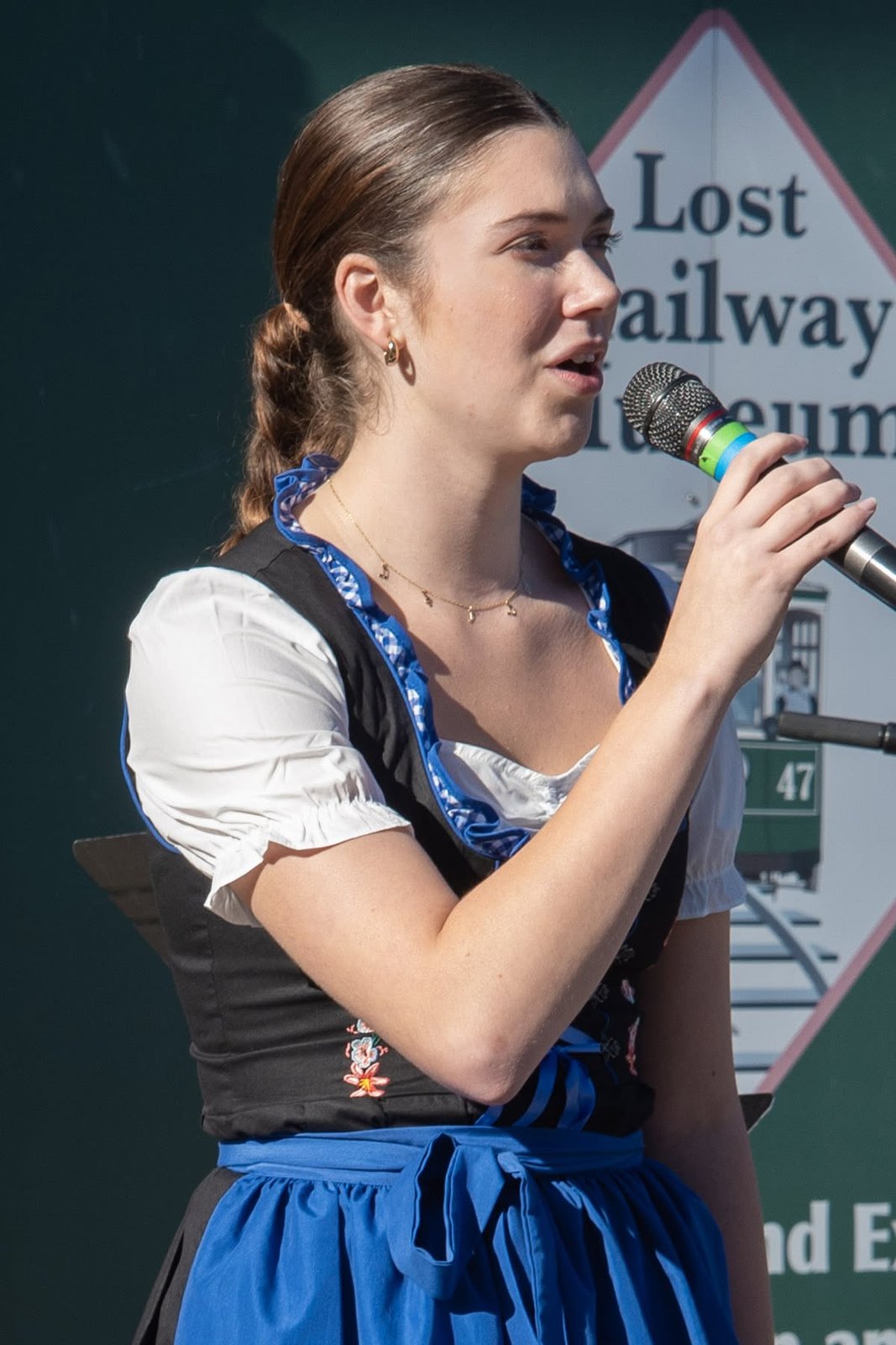 Singer performing near the Lost Railway Museum sign