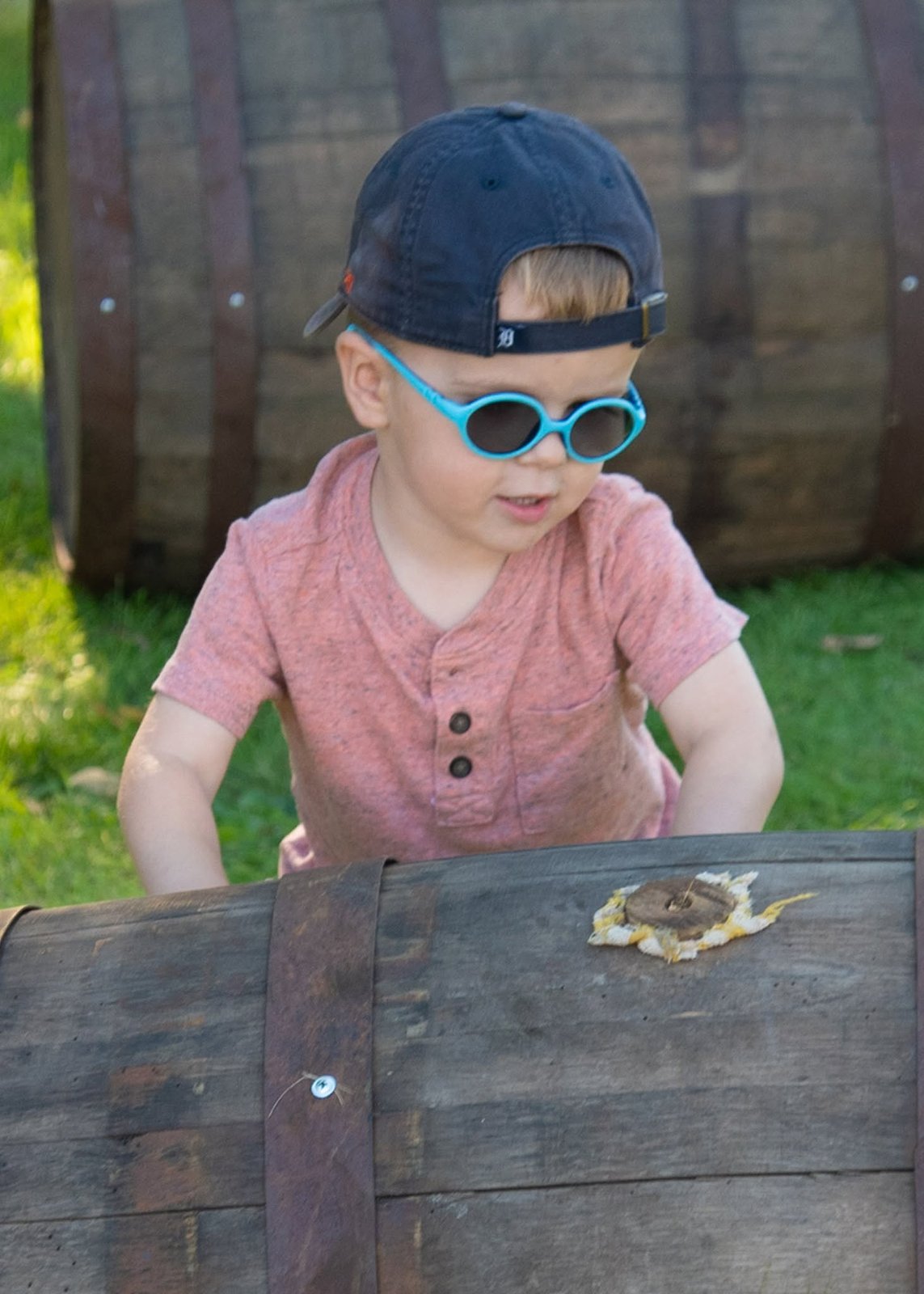 Boy in sunglasses with a barrel